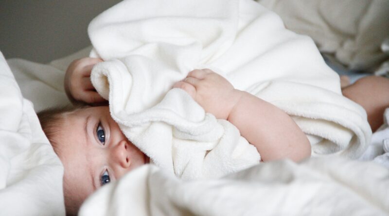 baby laying on bed