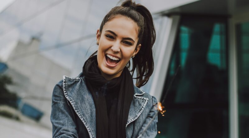 woman wearing gray denim jacket and black scarf